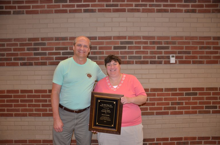 Phillip Clauer and Nicole Sciubba with the plaque recognizing her