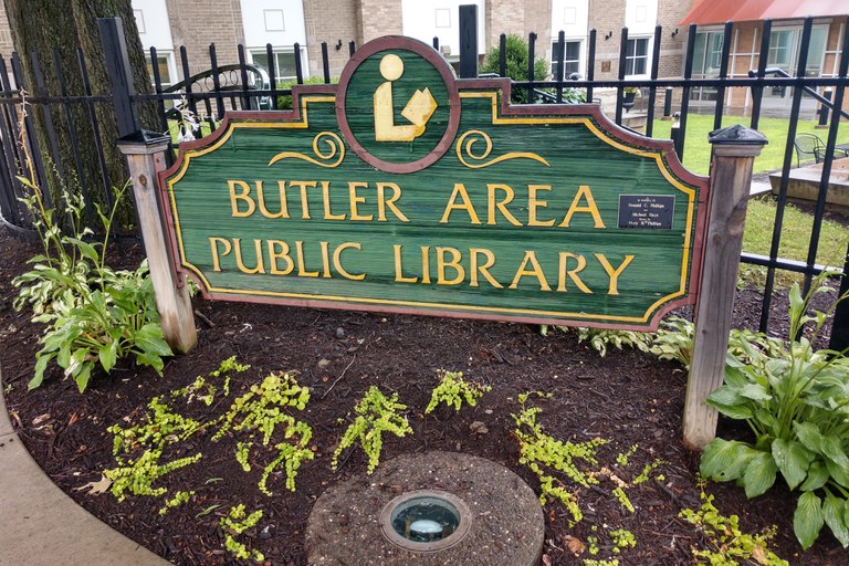 The Butler Area Public Library signs welcomes guests to the courtyard area.